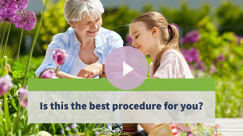 A senior woman looking at flowers in her garden with her little niece.