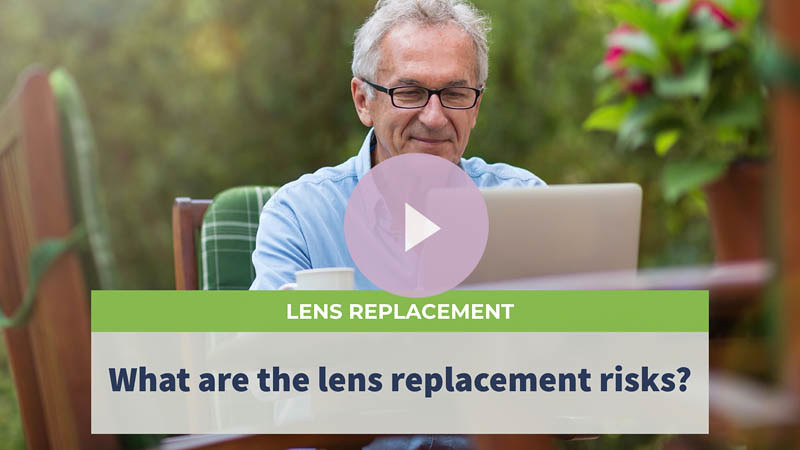 A senior man with glasses sitting in his garden, using his laptop.