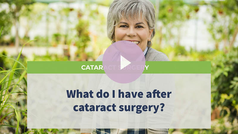 A senior woman in a garden, smiling at the camera.