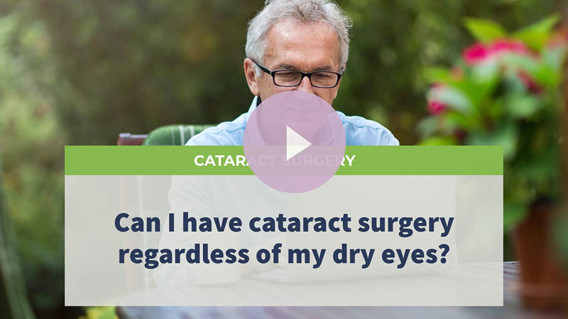 A senior man with glasses sitting in his garden, using his laptop.